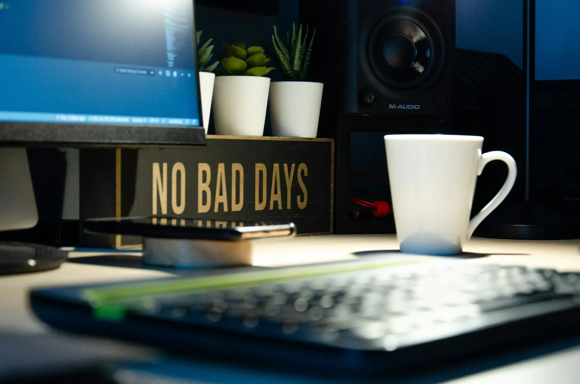 Developer desk set up with laptop and monitor, illustrative only